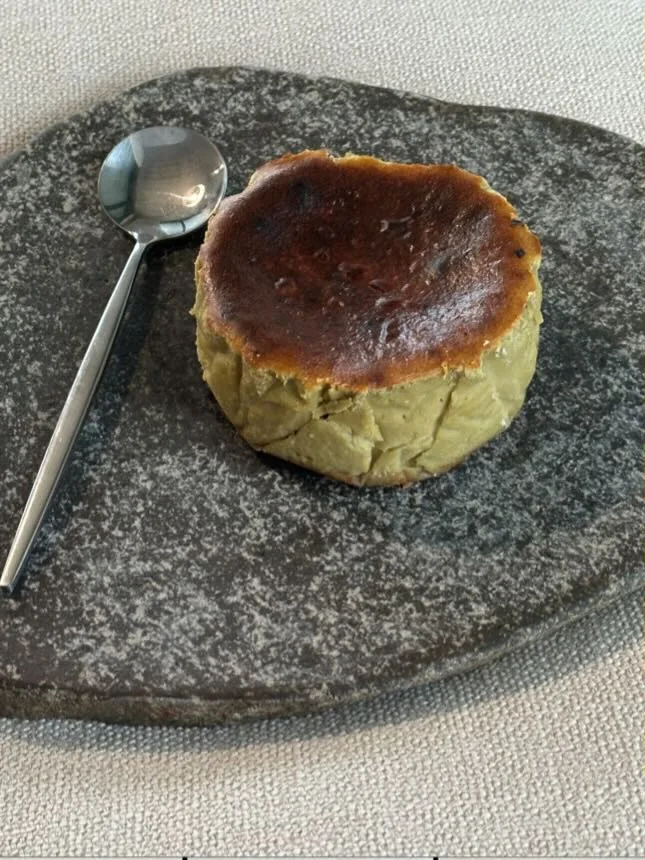 Pistachio tartza, whole, on the basalt slab with a spoon